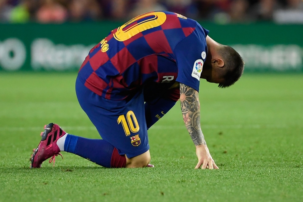 Barcelona's Argentine forward Lionel Messi reacts on the ground during the Spanish league football match between FC Barcelona and Villarreal CF at the Camp Nou stadium in Barcelona, on September 24, 2019. / AFP / LLUIS GENE