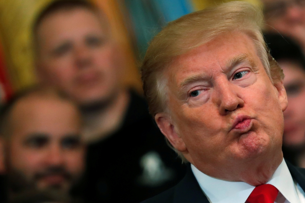 Donald Trump reacts after the release of Mueller report in the East Room of the White House, April 18, 2019. Reuters/Carlos Barria
 