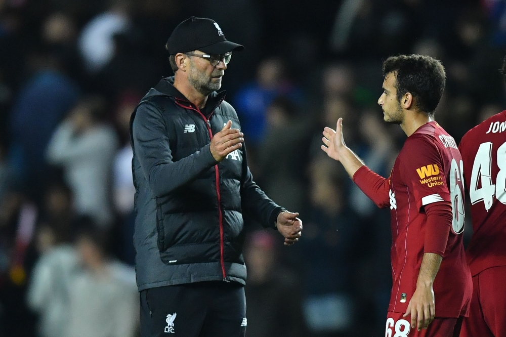 Liverpool's German manager Jurgen Klopp (L) reacts with Liverpool's Spanish midfielder Pedro Chirivella at the final whistle during the English League Cup third round football match between MK Dons and Liverpool at Stadium MK in Milton Keynes, Buckinghams