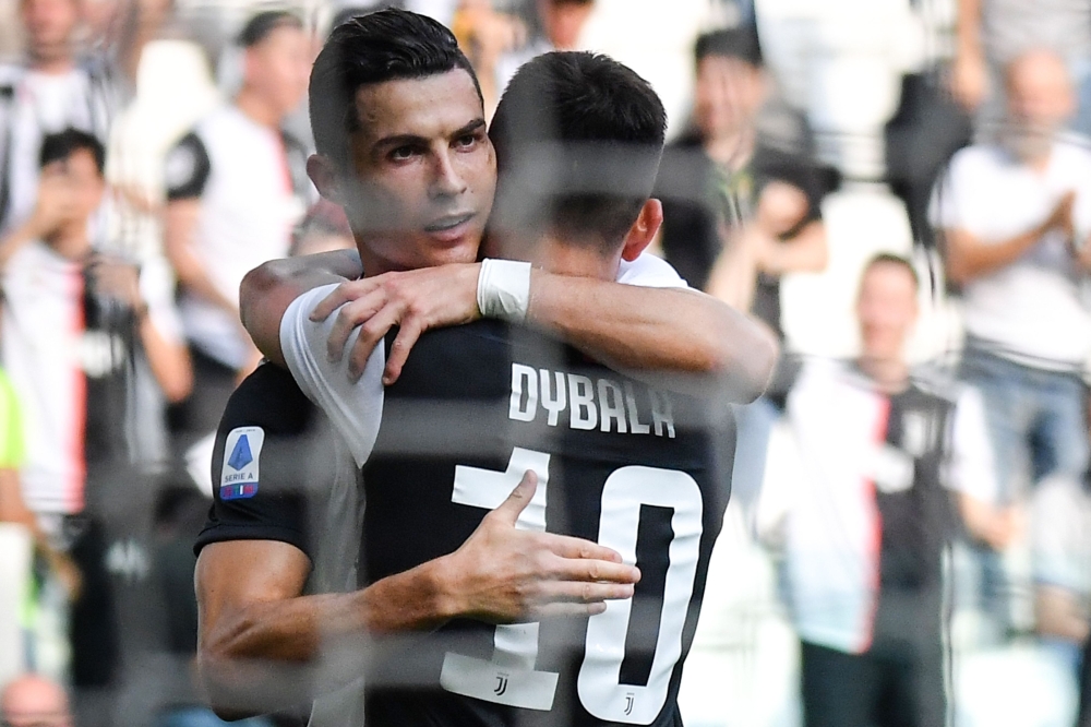 Juventus' Portuguese forward Cristiano Ronaldo celebrates with Juventus' Argentine forward Paulo Dybala after scoring during the Italian Serie A football match Juventus vs Spal on September 28, 2019 at the Juventus stadium in Turin. / AFP / Andreas SOLARO