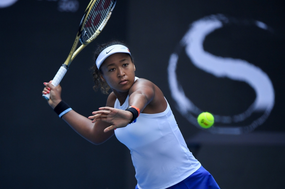 Naomi Osaka of Japan hits a return against Jessica Pegula of the US in their women's singles first round match at the WTA China Open tennis tournament in Beijing on September 29, 2019. / AFP / WANG ZHAO