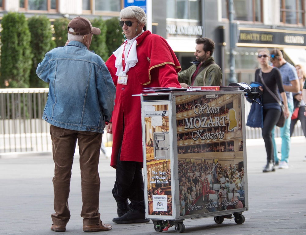 A street vendor tries to sell tickets for the Mozart and Strauss concerts in front of the Vienna State Opera on September 27, 2019. AFP / ALEX HALADA