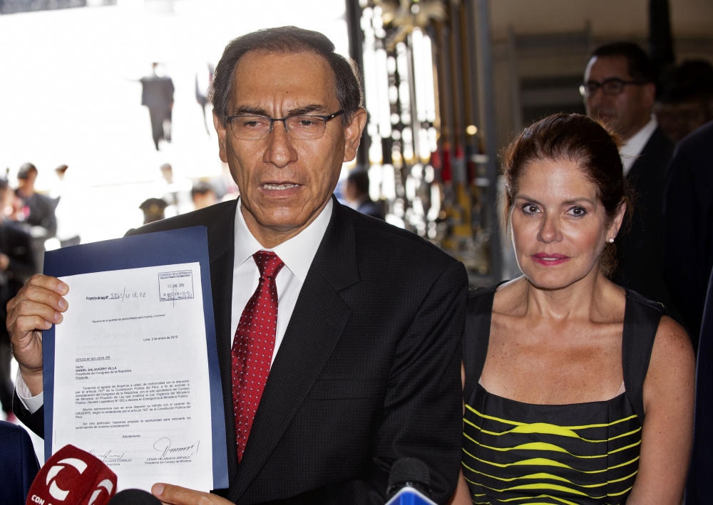  In this file picture taken on January 2, 2019 Peruvian President Martin Vizcarra (L), accompanied by Vice-President Mercedes Araoz, arrives at the Congress in Lima to deliver a bill that would declare the public prosecutor's office in a state of emergenc