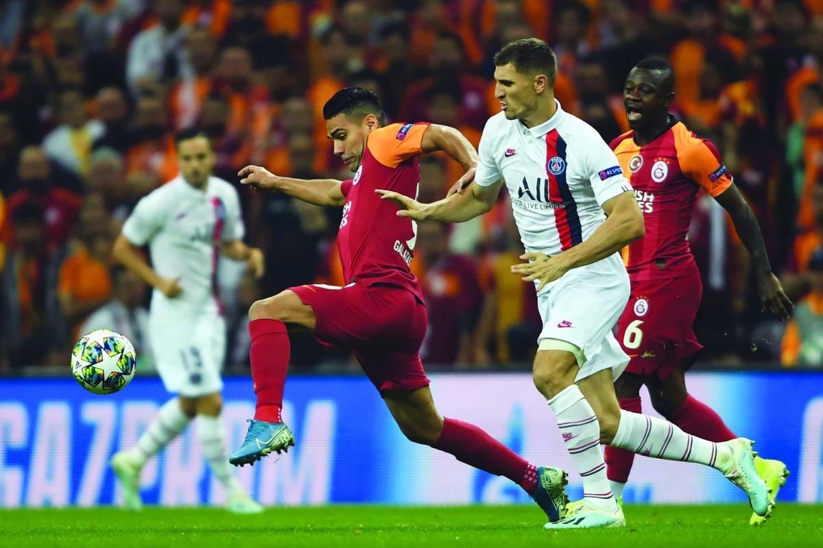 Galatasaray’s Colombian forward Radamel Falcao (left) vies with Paris Saint-Germain’s Belgian defender Thomas Meunier during the UEFA Champions League football match at Ali Sami Yen Spor Kompleksi in Istanbul yesterday.