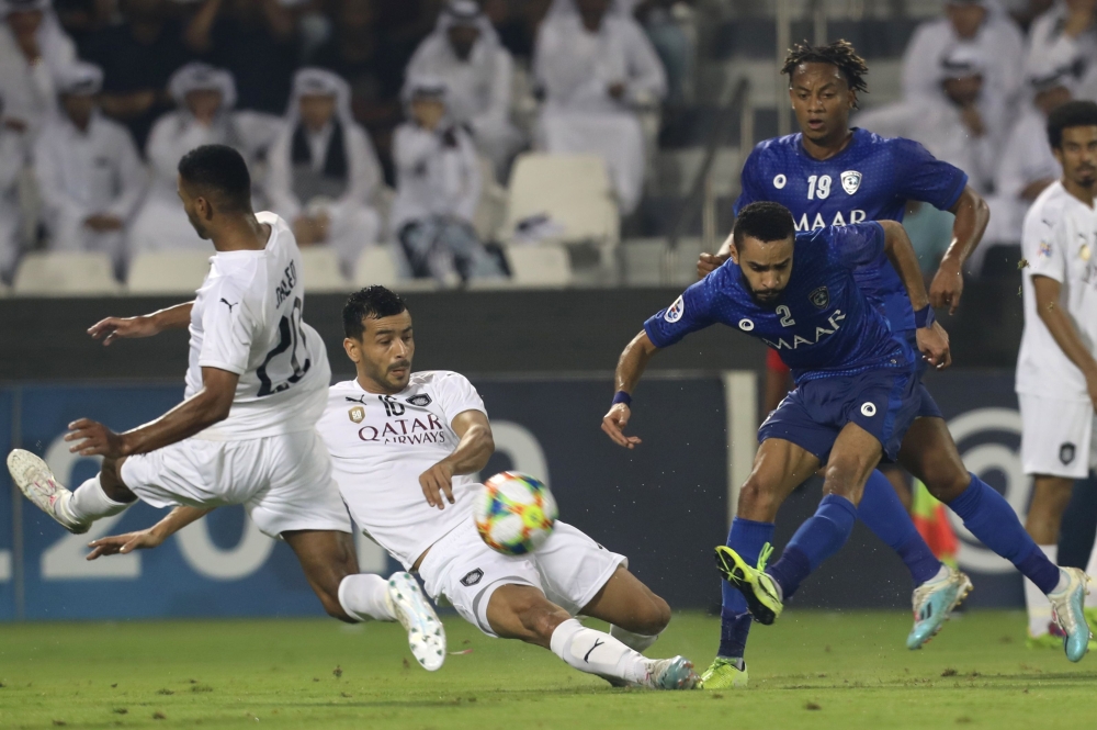 Sadd's Qatari midfielder Salem al-Hajri (L) Sadd's midfielder Boualem Khoukhi (2nd-L) and Hilal's defender Mohammed al-Breik (2nd-R) vie for the ball during the first leg of the AFC Champions League semi-finals football match between Qatar's Al Sadd and S