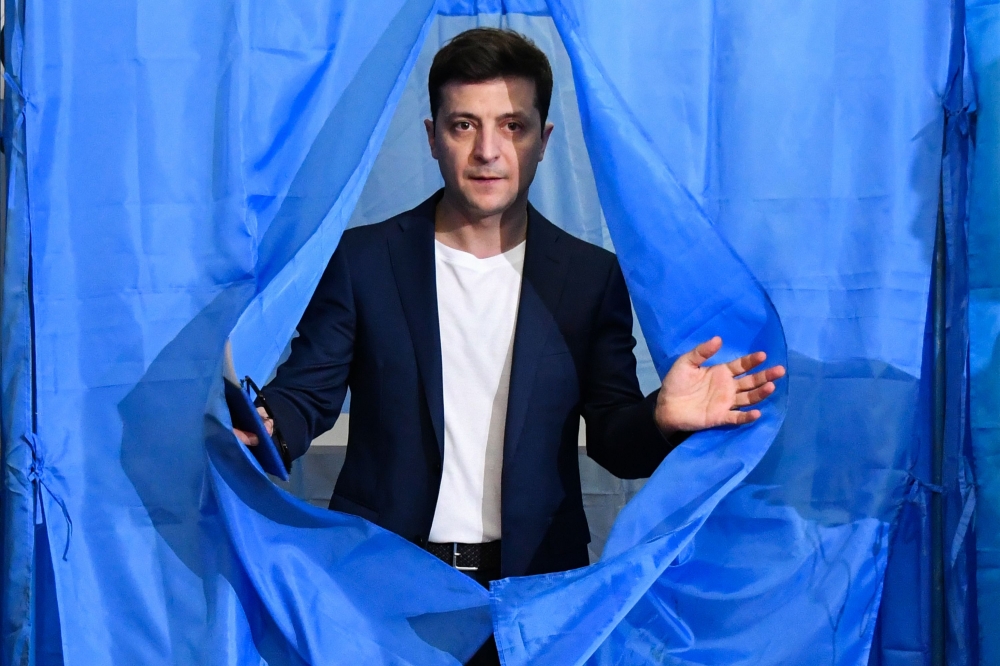 Volodymyr Zelensky walks out of a voting booth at a polling station during the second round of Ukraine presidential election in Kiev on April 21, 2019. AFP / Genya Savilov