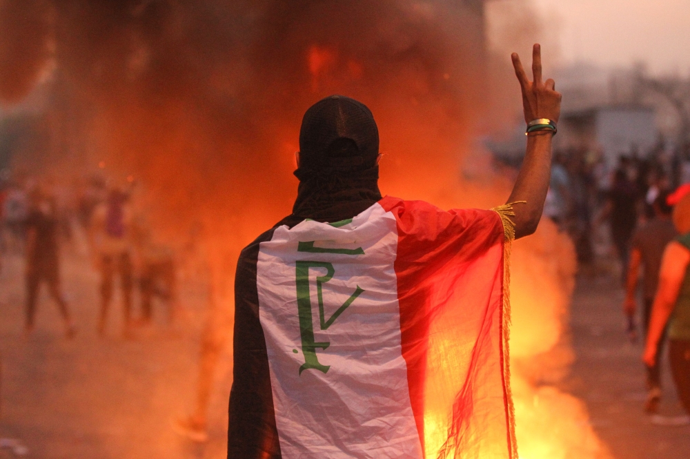 An Iraqi protester gestures the v-sign during a demonstration against state corruption, failing public services and unemployment at Tayaran square in Baghdad on October 2, 2019. AFP / AHMAD AL-RUBAYE