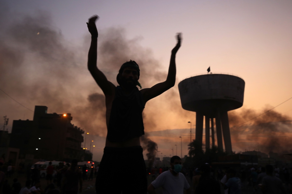 An Iraqi protester chants slogans during a demonstration against state corruption, failing public services and unemployment at Tayaran square in Baghdad on October 2, 2019.   AFP / AHMAD AL-RUBAYE