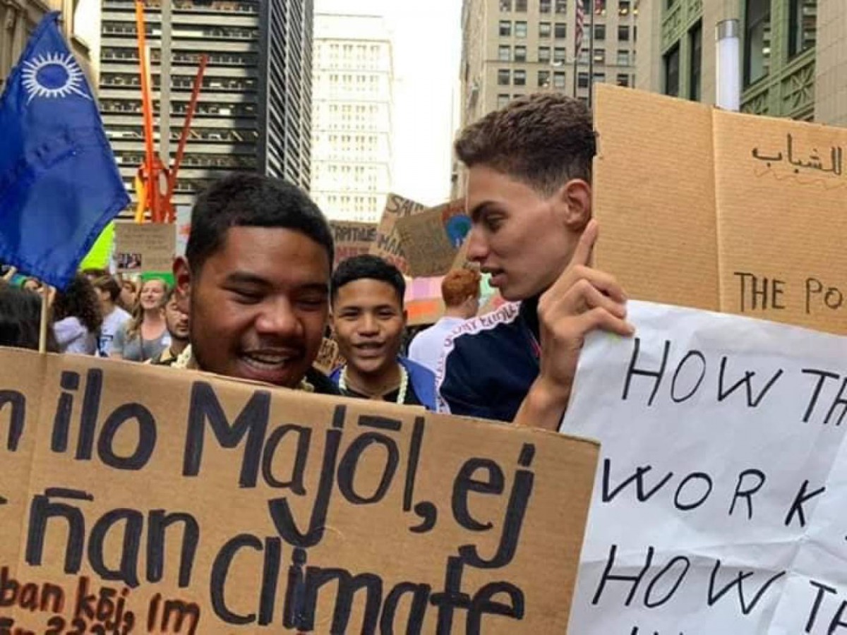 Tunisian youth climate activist Raslen Jbeli (right) marches at a September protest in New York City. Photo: Chadlia Zammeli
