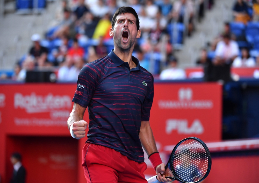 Serbia's Novak Djokovic reacts following a point against Belgium's David Goffin in their men's singles semi-final match at the Japan Open tennis tournament in Tokyo on October 5, 2019. / AFP / Kazuhiro Nogi 