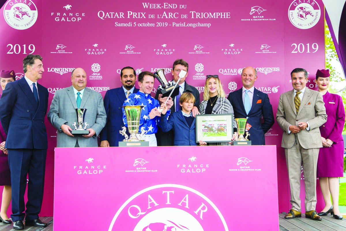 Raahah’s owner H H Sheikh Mohamed bin Khalifa Al Thani, jockey and the support team members celebrate with the trophy after winning the Gr1 PA Qatar Arabian Trophy Des Juments for four-year-old mares at ParisLongchamp on Day 1 of the Qatar Prix de l’Arc d