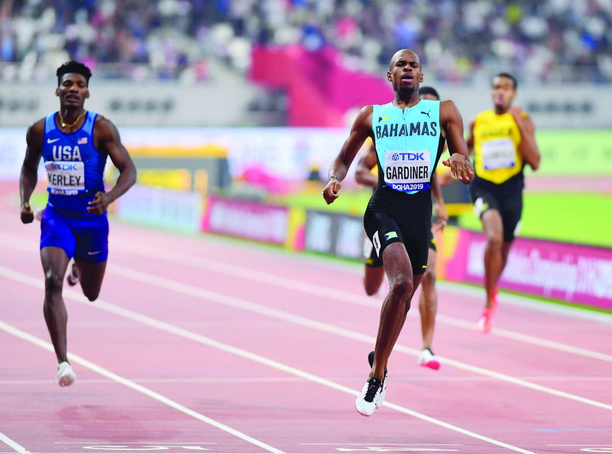 Bahamas’ Steven Gardiner (centre) crossing the finish line in the Men’s 400m final to win the gold medal on Friday.