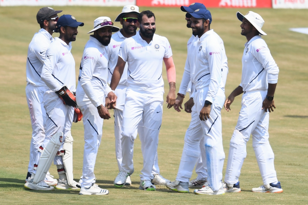 Indian cricketer Mohammed Shami (C) celebrates with teammates after the dismissal of South African cricketer Quinton de Kock during the fifth day's play of the first Test match between India and South Africa at the Dr. Y.S. Rajasekhara Reddy ACA-VDCA Cric