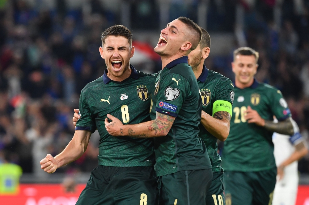 Italy's midfielder Jorginho (L) celebrates with Italy's midfielder Marco Verratti after scoring his team's first goal during the UEFA Euro 2020 Group J qualifier football match between Italy and Greece at the Stadio Olimpico stadium in Rome, on October 12