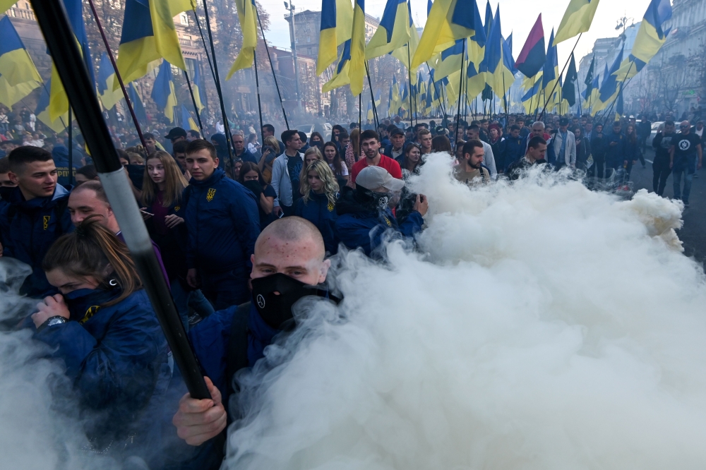 Activists and supporters of nationalist forces march in downtown Kiev on October 14, 2019. AFP / Genya Savilov 
 