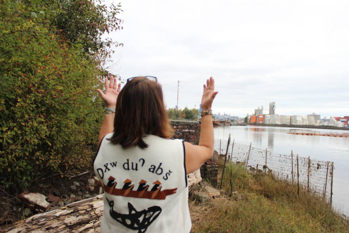 Duwamish Tribal Services Executive Director Jolene Haas holds up her hands, a traditional gesture of gratitude, on the banks of the Duwamish River in Seattle, USA. Thomson Reuters Foundation/Gregory Scruggs