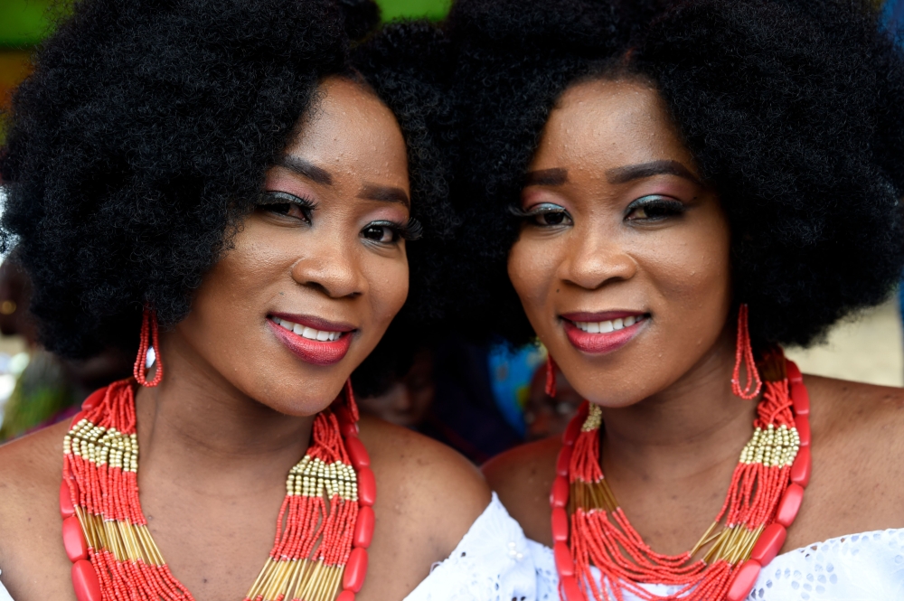 Identical twin sisters Kehinde Olofin (L) and Taye Olofin (R) attends Igbo-Ora World Twins festival to celebrate the uniqueness in multiple births at Igbo-Ora Town in Oyo State, southwest Nigeria, on October 12, 2019. AFP / PIUS UTOMI EKPEI