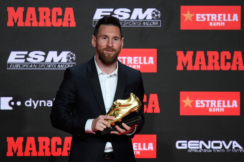 Barcelona's Argentinian forward Lionel Messi poses with his sixth Golden Shoe award after receiving the 2019 European Golden Shoe honoring the year's leading goalscorer during a ceremony at the Antigua Fabrica Estrella Damm in Barcelona on October 16, 201