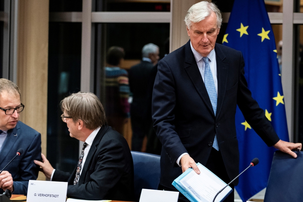 European Union's chief Brexit negotiator Michel Barnier (R) arrives for a meeting at the European Parliament in Brussels, on October 16, 2019. / AFP / Kenzo TRIBOUILLARD
