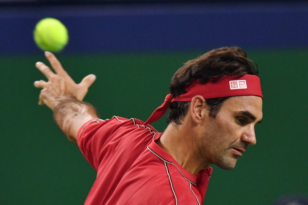 Roger Federer of Switzerland hits a return against Alexander Zverev of Germany during their men's singles quarter-final match at the Shanghai Masters tennis tournament in Shanghai on October 11, 2019. / AFP / HECTOR RETAMAL