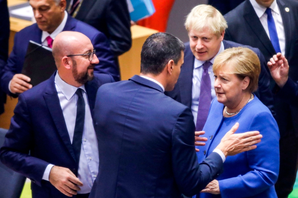 German Chancellor Angela Merkel (R), British Prime Minister Boris Johnson (2nd R), Spanish Prime Minister Pedro Sanchez (C) and Belgian Prime Minister Charles Michel (L) speak together upon their arrival to attend a round table meeting as part of a Europe