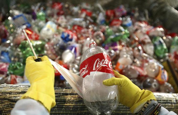 A worker removes labels from recycled plastic bottles to be used in the construction of the sailboat Plastiki at Pier 31 in San Francisco California March 13 2009 Reuters Robert Galbraith