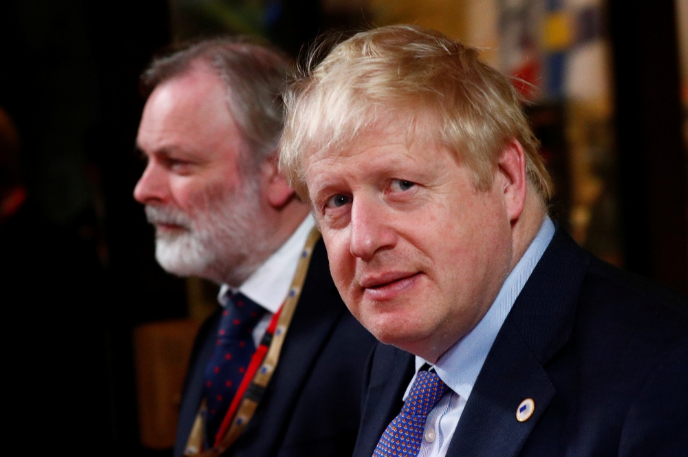 Prime Minister Boris Johnson and British Permanent Representative to the EU Tim Barrow depart the European Council after EU leaders summit in Brussels, October 18, 2019. Reuters/Francois Lenoir
