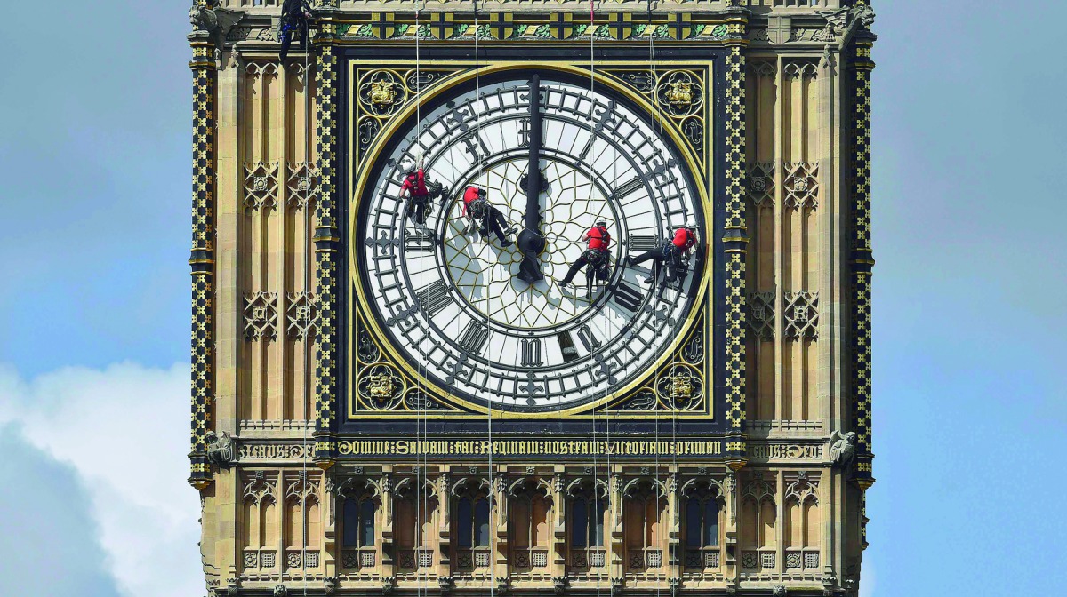 Cleaners abseil down one of the faces of Big Ben to clean and polish the clock face above the Houses of Parliament in central London, August 19, 2014. Reuters/Toby Melville