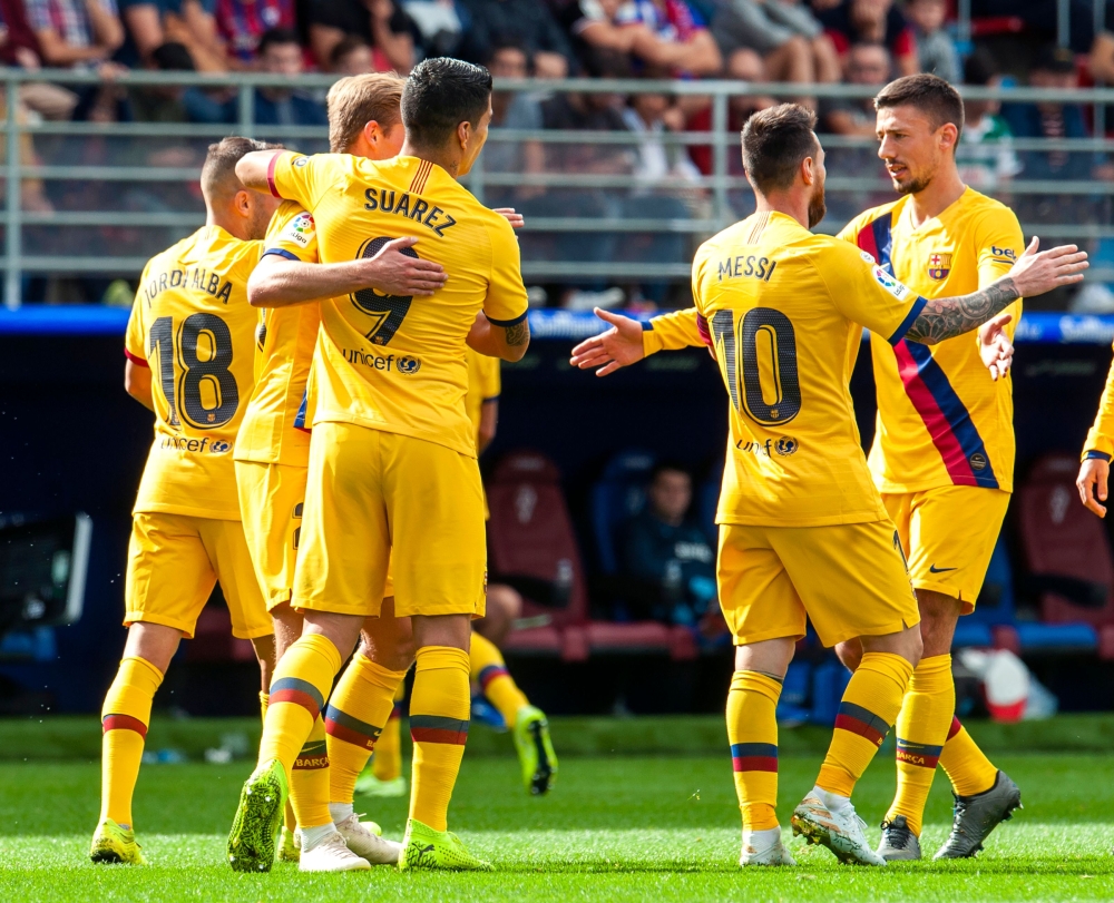 Barcelona's Argentine forward Lionel Messi (L) celebrates after scoring during the Spanish league football match SD Eibar against FC Barcelona at the Ipurua stadium in Eibar on October 19, 2019. / AFP 