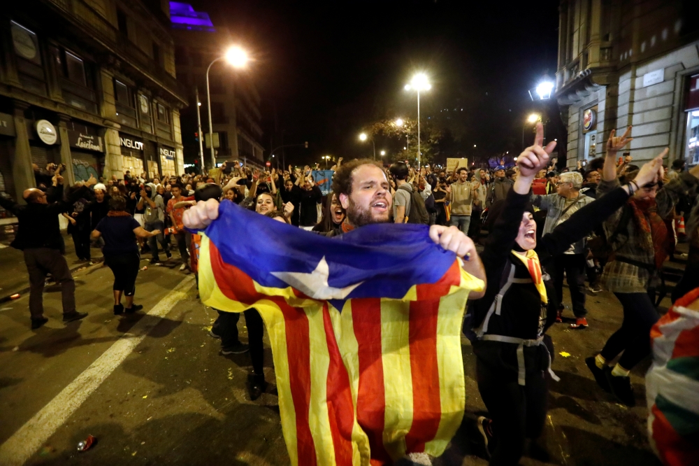 Demonstrators celebrate after police leave the area during a protest, after a verdict in a trial over a banned independence referendum, in Barcelona, Spain, October 20, 2019. REUTERS/Jon Nazca