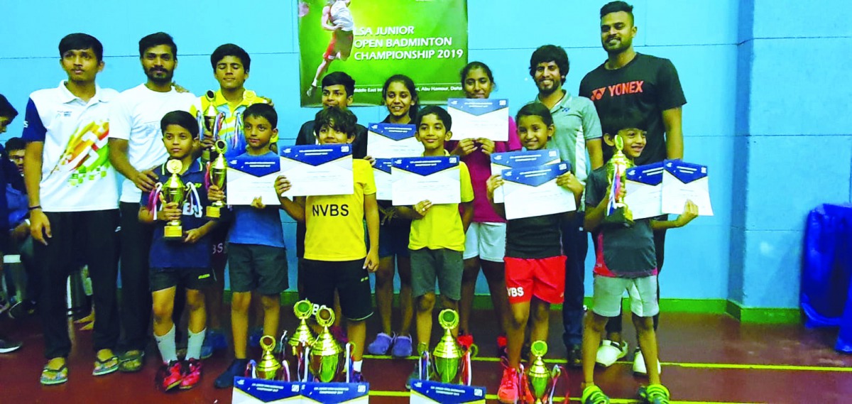The winners from New Vision Badminton Sports, posing for a group photo along with  the chief coach. Manoj Sahibjan, coach Mohammed Rafi (extreme right) coach Salam and coach Aadharsh (extrme left).