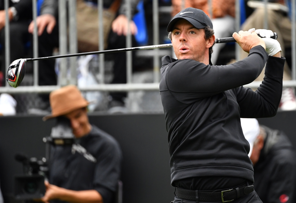Rory McIlroy of Northern Ireland tees off at the first hole at a