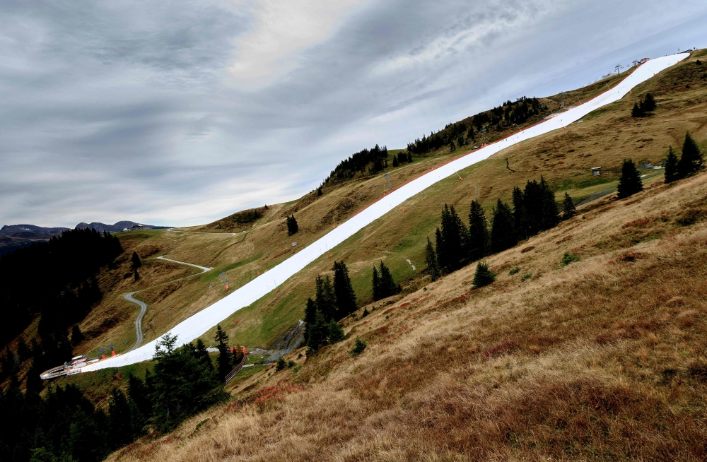Picture shows a downhill slope, covered with conserved snow from last winter, at the Resterhoehe of Kitzbuehel ski resort, near Mittersill, Austria on October 20, 2019. AFP / JOE KLAMAR 