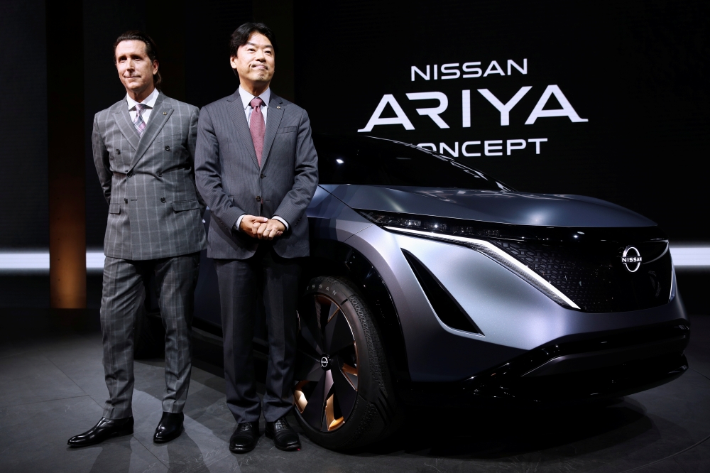 Alfonso Albaisa, Nissan's Senior Vice President for Global Design and Kunio Nakaguro, Nissan's Executive Vice President of R and D pose next to Nissan's Ariya concept car during the Tokyo Motor Show, in Tokyo, Japan October 23, 2019. REUTERS/Edgar Su