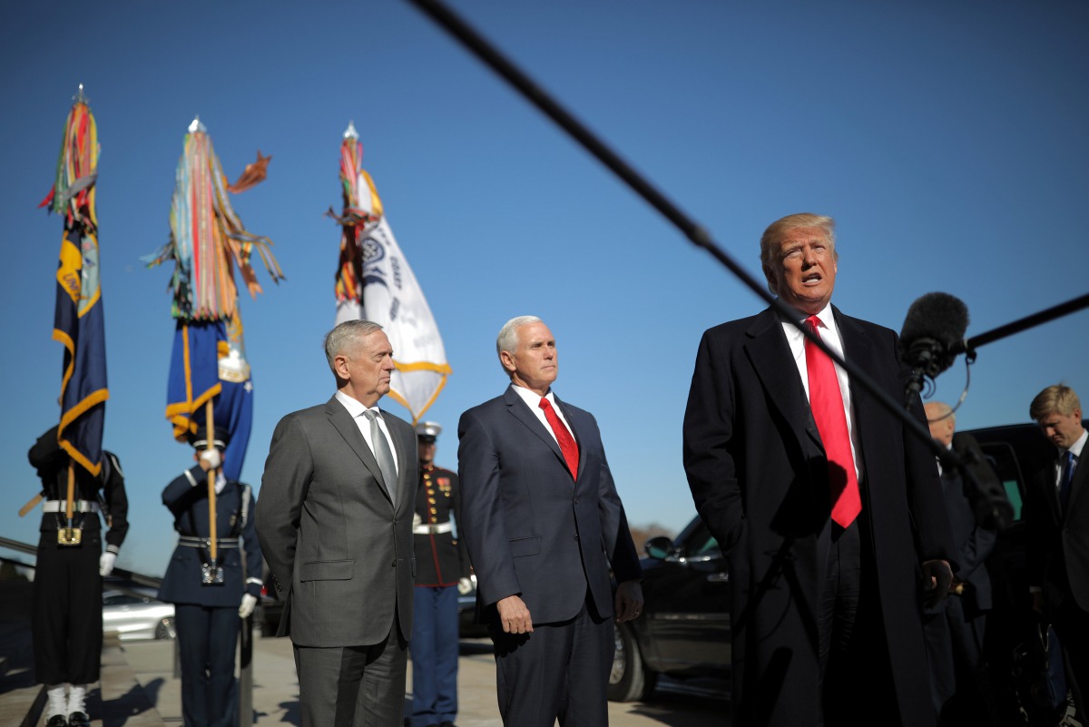 Donald Trump speaks to reporters as he arrives for a meeting at the Pentagon, accompanied by Defense Secretary Jim Mattis, VP Mike Pence in Arlington, Virginia, January 18, 2018. Reuters / Carlos Barria