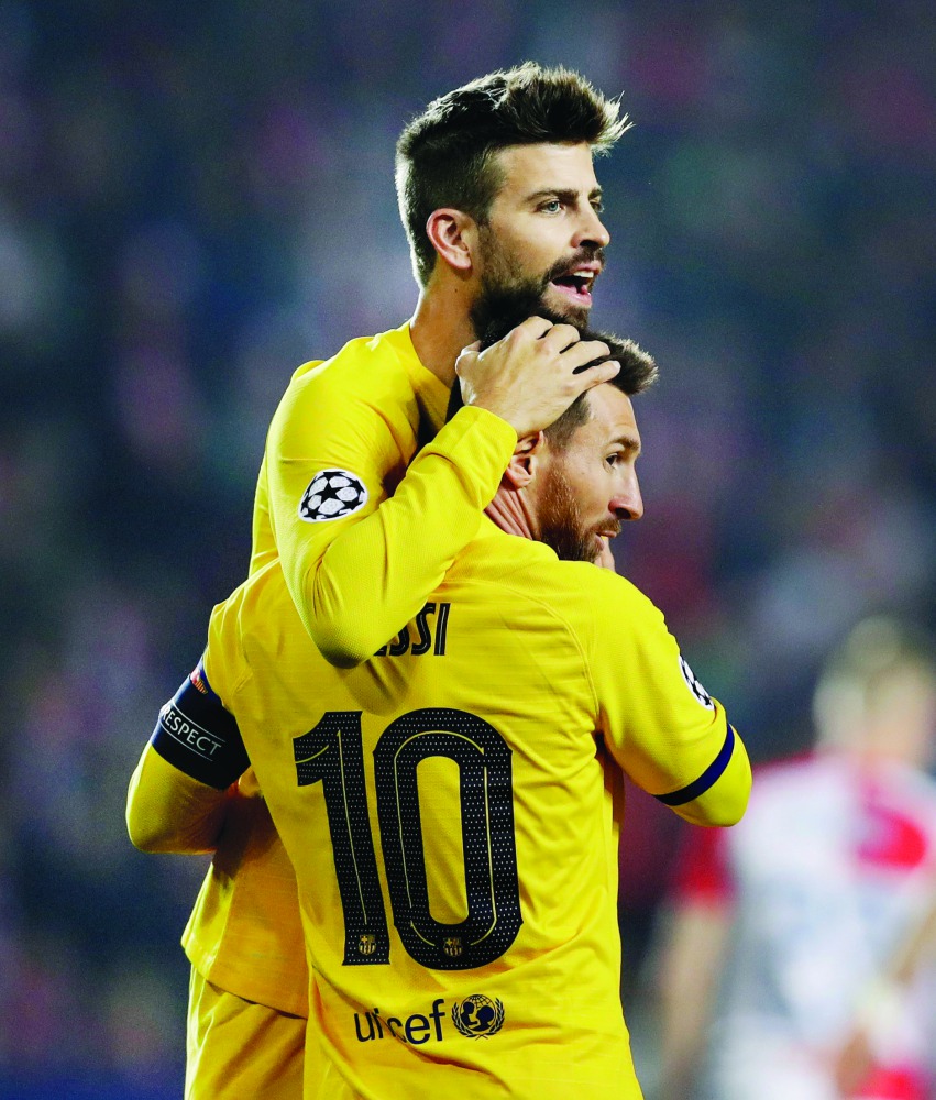 Barcelona's Lionel Messi celebrates scoring their first goal with Gerard Pique. Reuters/David W Cerny