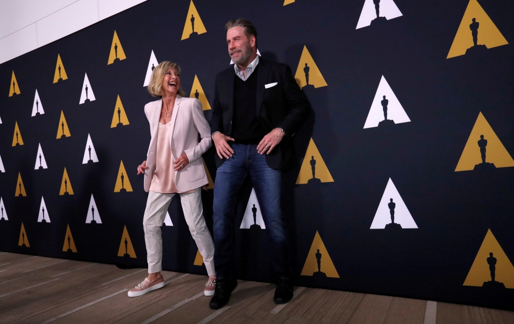 FILE PHOTO: Cast members John Travolta and Olivia Newton-John dance at a 40th-anniversary screening of 