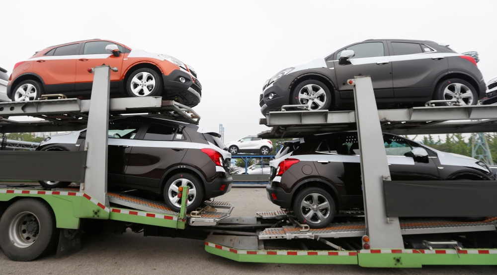 FILE PHOTO: Cars made by GM Korea are seen on trucks in a yard of GM Korea Bupyeong plant before they are transported to a port for export in Incheon, west of Seoul, August 9, 2013. Reuters / Lee Jae-Won