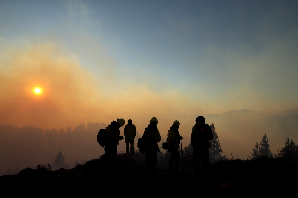 Firefighters monitor the Kincade Fire on October 29, 2019 in Healdsburg, California. Justin Sullivan/Getty Images/AFP