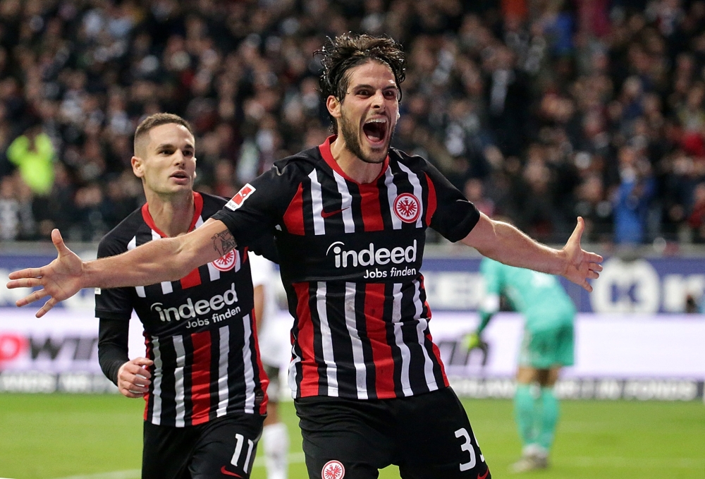 Frankfurt's Portuguese forward Goncalo Paciencia (R) celebrates with Frankfurt's Serbian midfielder Mijat Gacinovic after scoring the 5-1 during the German first division Bundesliga football match between Eintracht Frankfurt and FC Bayern Munich on Novemb
