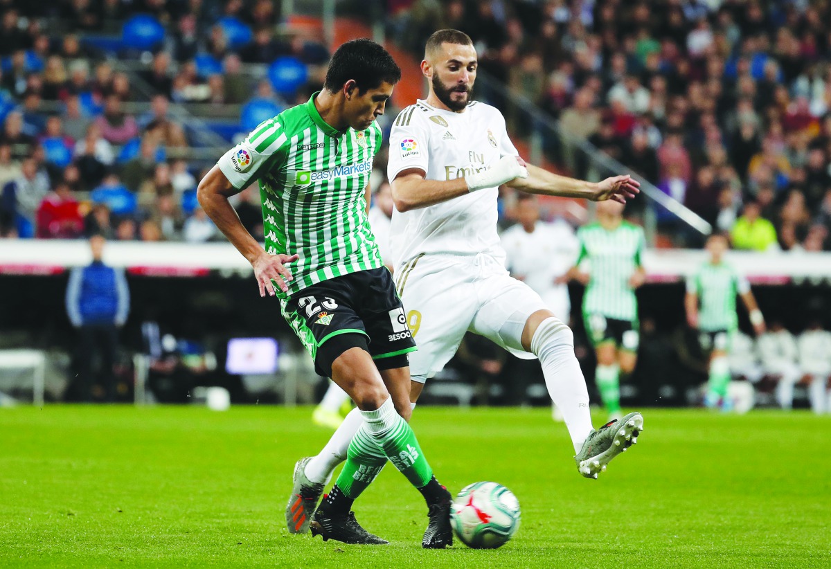 Karim Benzema of Real Madrid in action against Aissa Mandi of Real Betis Balompie during the La Liga match at Santiago Bernabeu Stadium on November 02, 2019 in Madrid, Spain. (Burak Akbulut/Anadolu Agency)