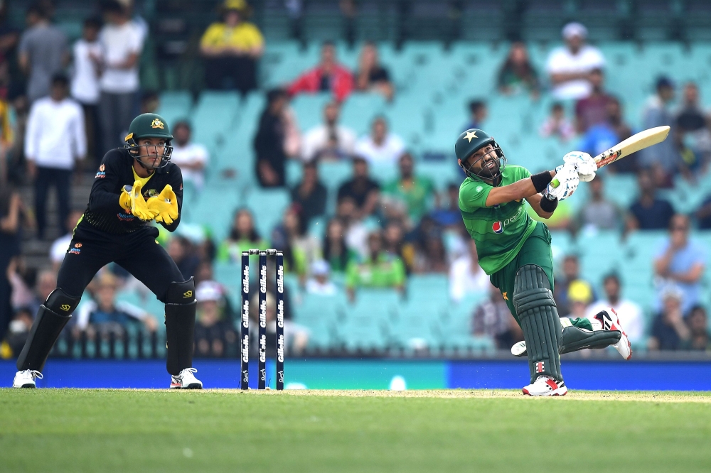 Pakistan's Muhammad Rizwan (R) plays a shot during the Twenty20 cricket match between Australia and Pakistan at the Sydney Cricket Ground in Sydney on November 3, 2019