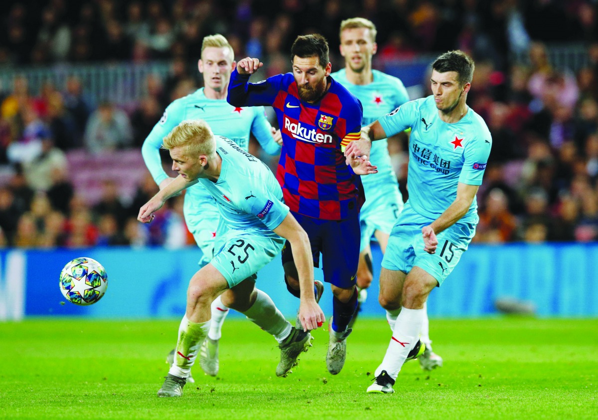 Barcelona's Lionel Messi in action with SK Slavia Prague's Michal Frydrych and Ondrej Kudela Reuters/Albert Gea
 
