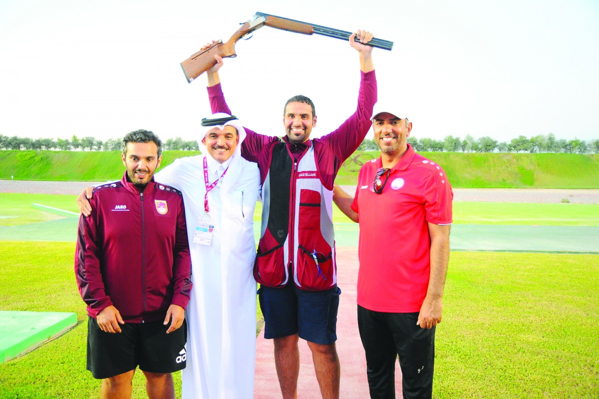 Mohamed Al Rumaihi (second right) celebrates with Qatar Shooting and Archery Association President Ali Mohamed Al Kuwari, on getting the Olympic quota yesterday.