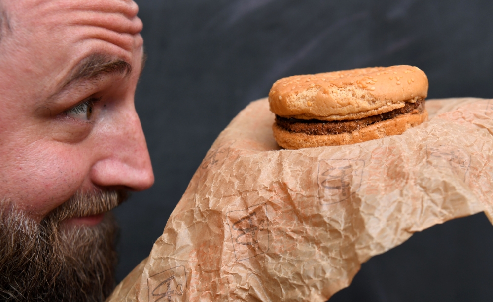 Casey Dean inspects a McDonald's burger bought in 1995 and kept in an Australian shed for years... AFP / William West 