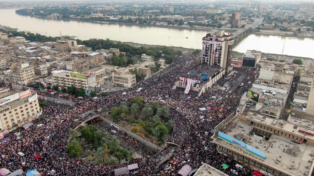 An aerial view shows Iraqi protesters gathering at Baghdad's Tahrir square near al-Jumhuriya bridge which leads to the high-security Green Zone across the Tigris River, during ongoing anti-government demonstrations on November 2, 2019.  AFP