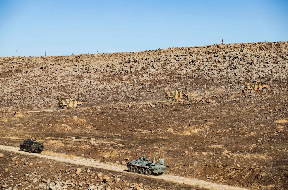 Russian and Turkish military vehicles take part in a joint patrol near the town of Al-Muabbadah in the northeastern Syrian Hassake province on the border with Turkey, on November 8, 2019. AFP / Delil Souleiman 