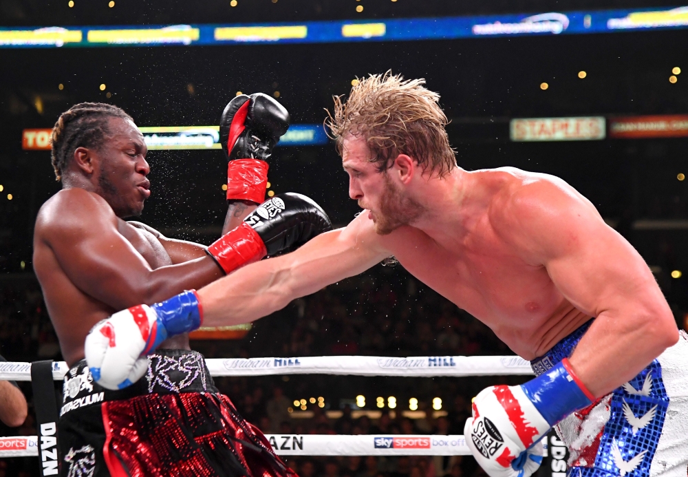 LOS ANGELES, CA - NOVEMBER 09: Logan Paul (red/white/blue shorts) and KSI (black/red shorts) exchange punches their pro debut fight at Staples Center on November 9, 2019 in Los Angeles, California. KSI won by decision /AFP
