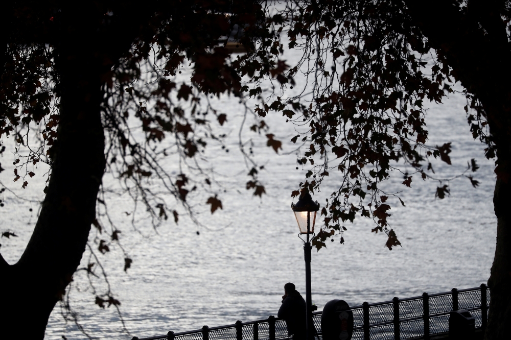 A man looks at the Thames in London, Britain November 5, 2019. REUTERS/Yara Nardi