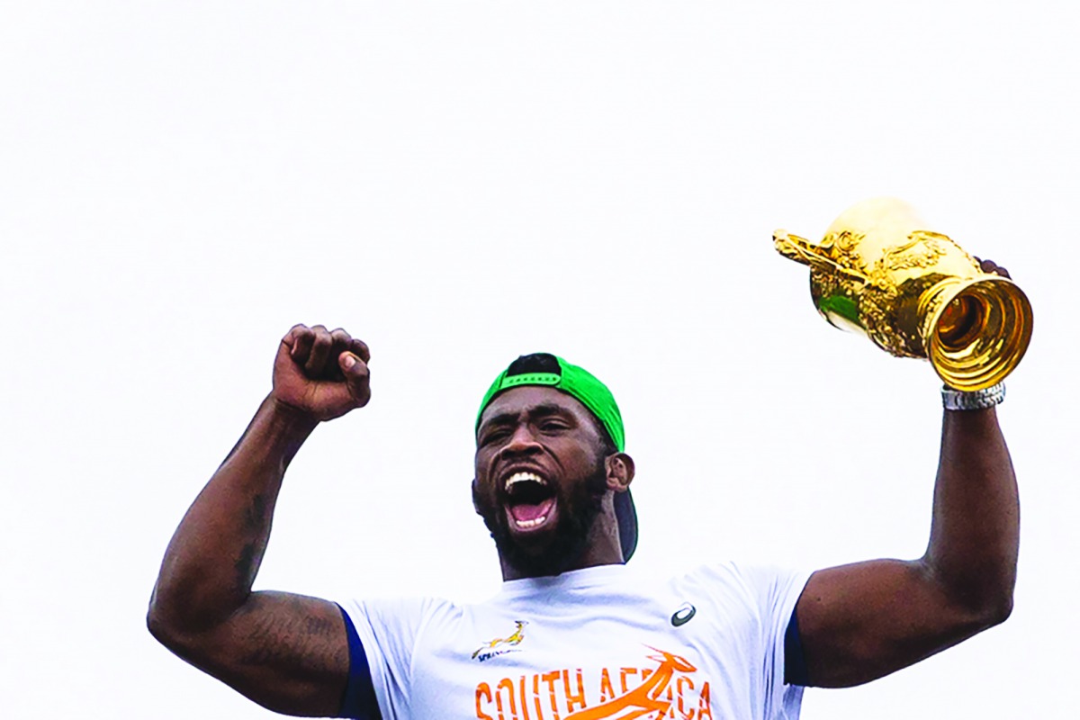 South African Rugby captain Siya Kolisi holds up the Web Ellis Trophy while the South African Rugby World Cup winner team parades on an open top bus through the streets of the city of Zwide , Port Elizabeth, on November 10, 2019. AFP / Wikus De Wet

